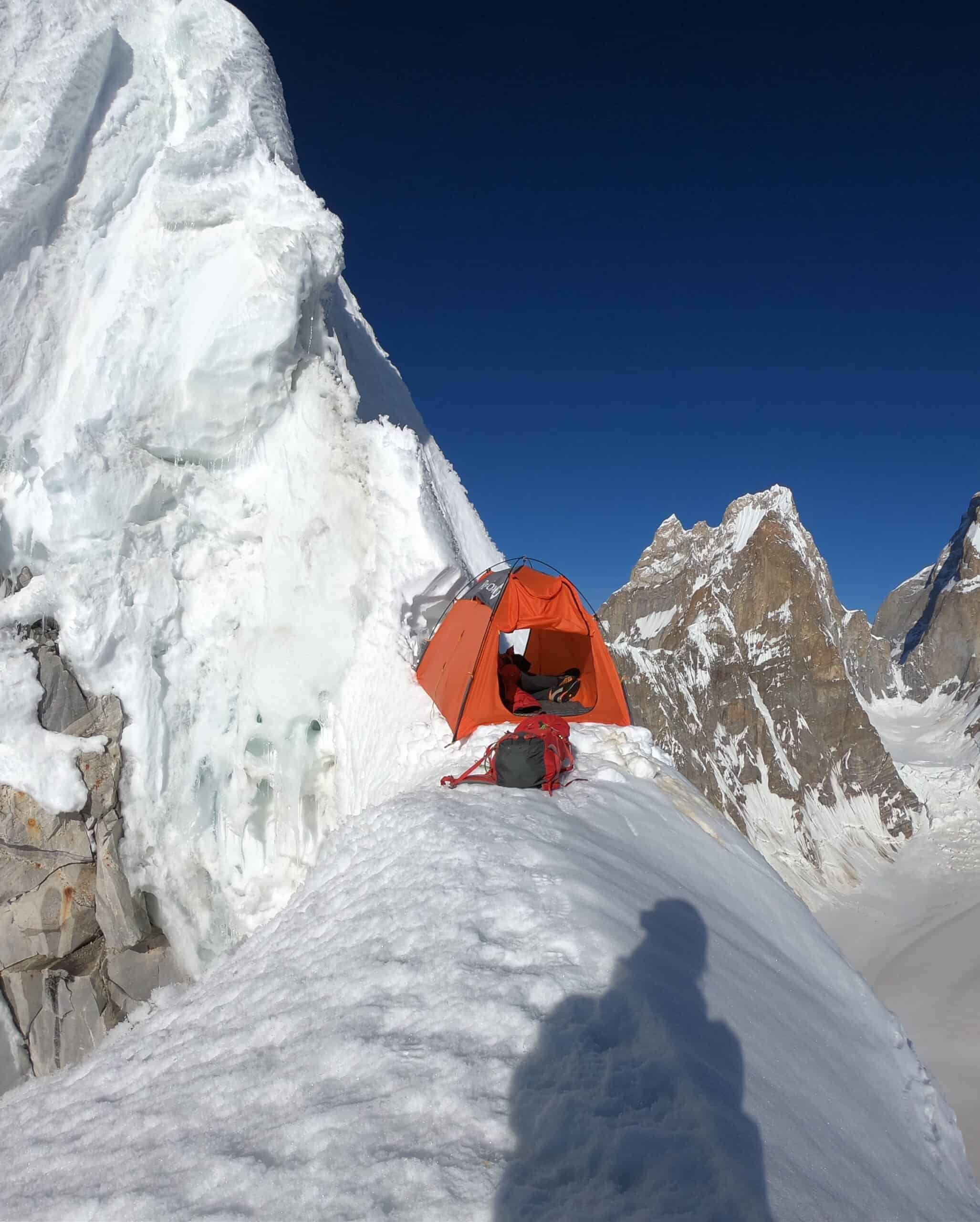 High-altitude alpine expedition camp on exposed mountain ridge