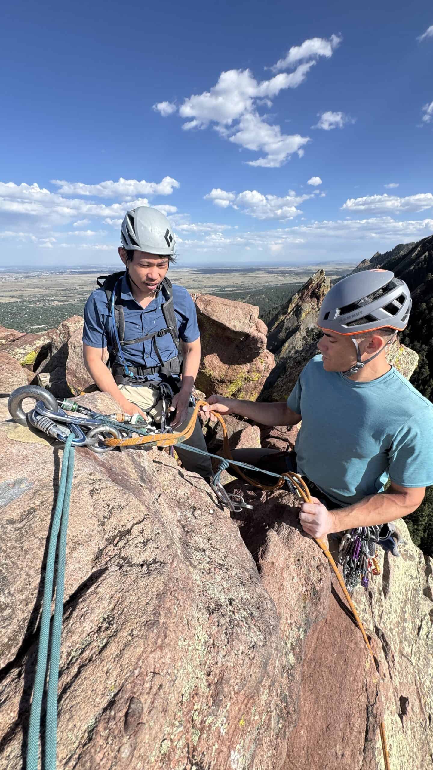 Instructor teaching multi-pitch trad anchor systems in Boulder Canyon, Colorado