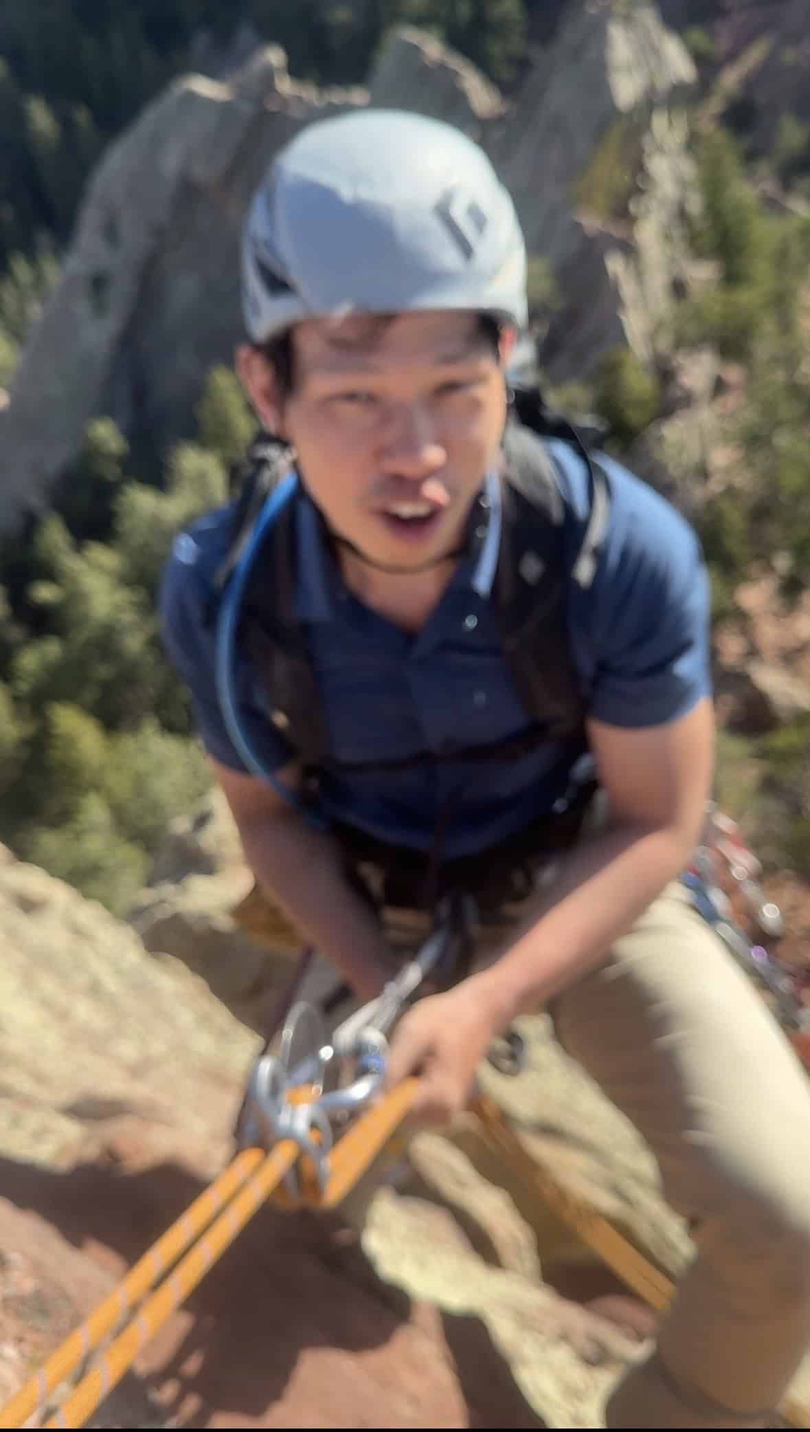 Climber managing rope systems at a trad anchor in Boulder Canyon