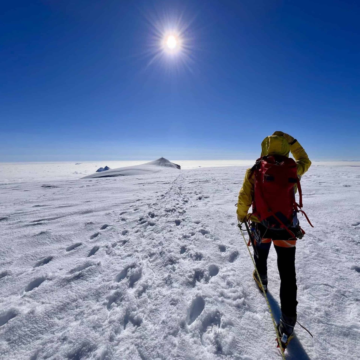 Private mountaineering guide leading alpine expedition across glacier terrain
