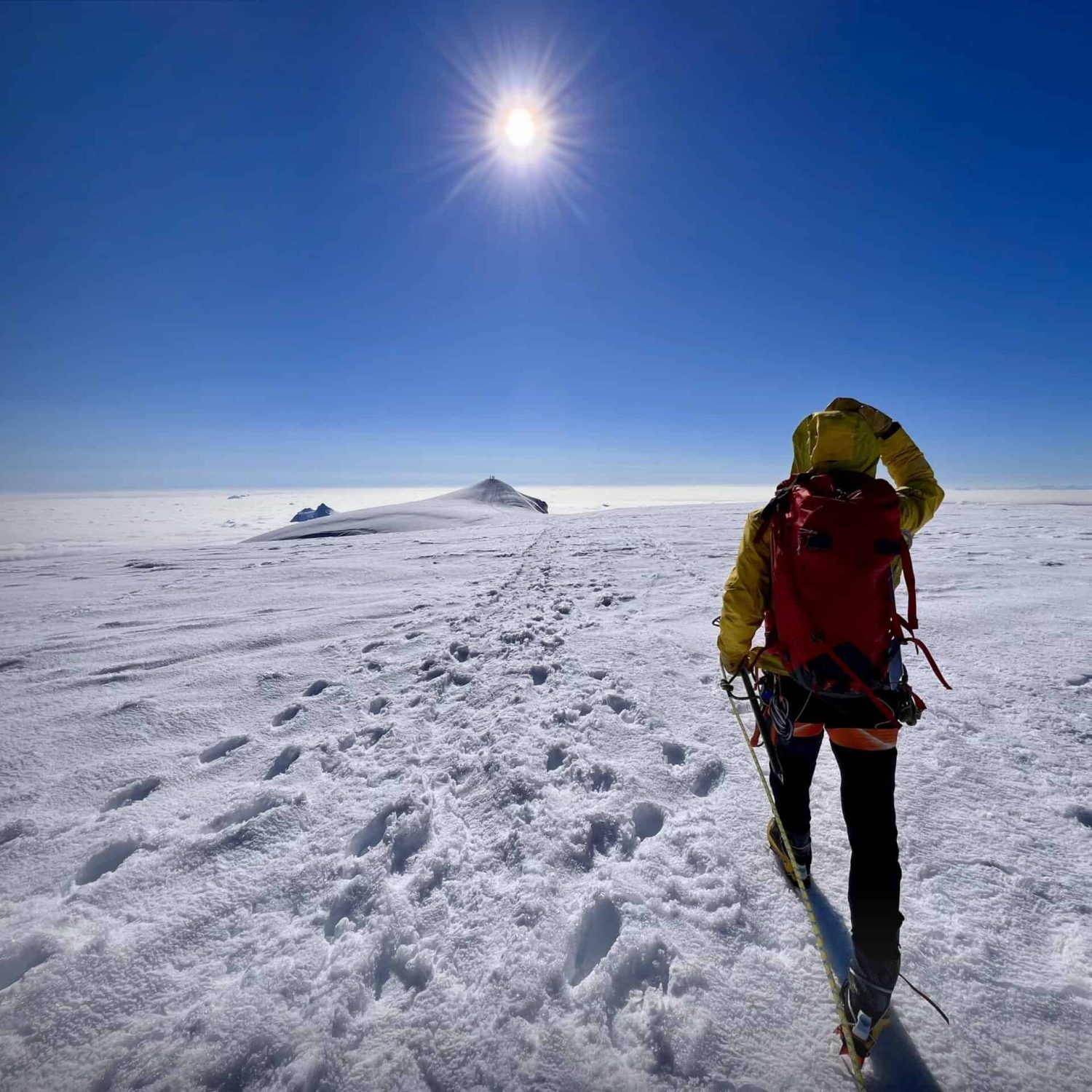 Private mountaineering guide leading alpine expedition across glacier terrain
